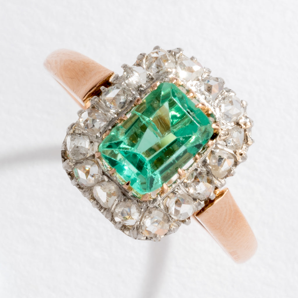 Bague entourage émeraude et diamant.