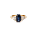 Emerald-cut sapphire ring flanked by two triangular-cut diamonds