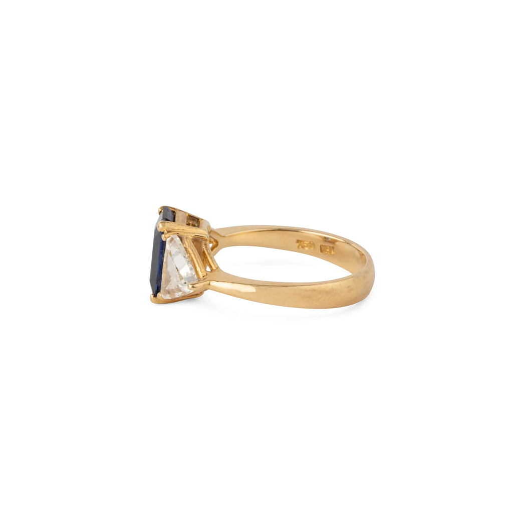 Emerald-cut sapphire ring flanked by two triangular-cut diamonds