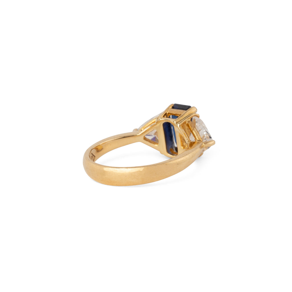 Emerald-cut sapphire ring flanked by two triangular-cut diamonds