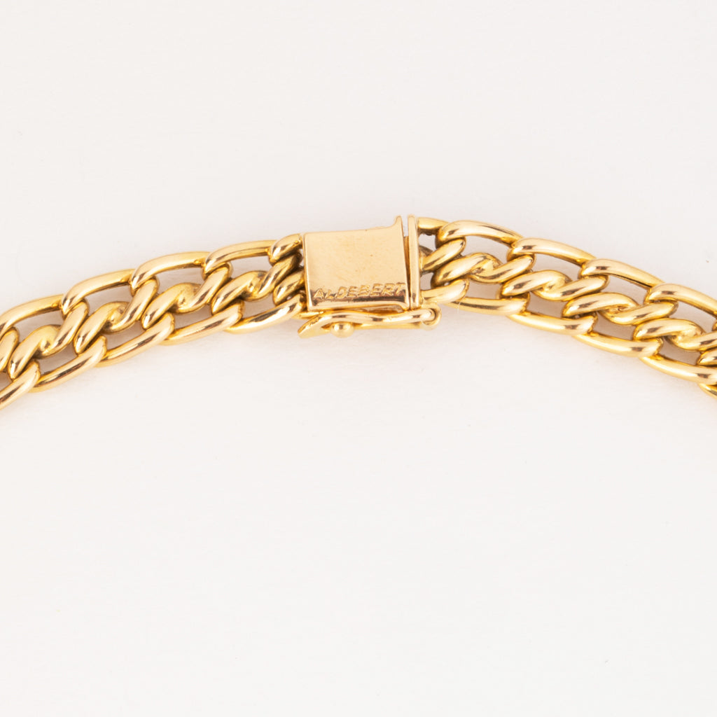 Yellow gold curb chain necklace interspersed with diamond links