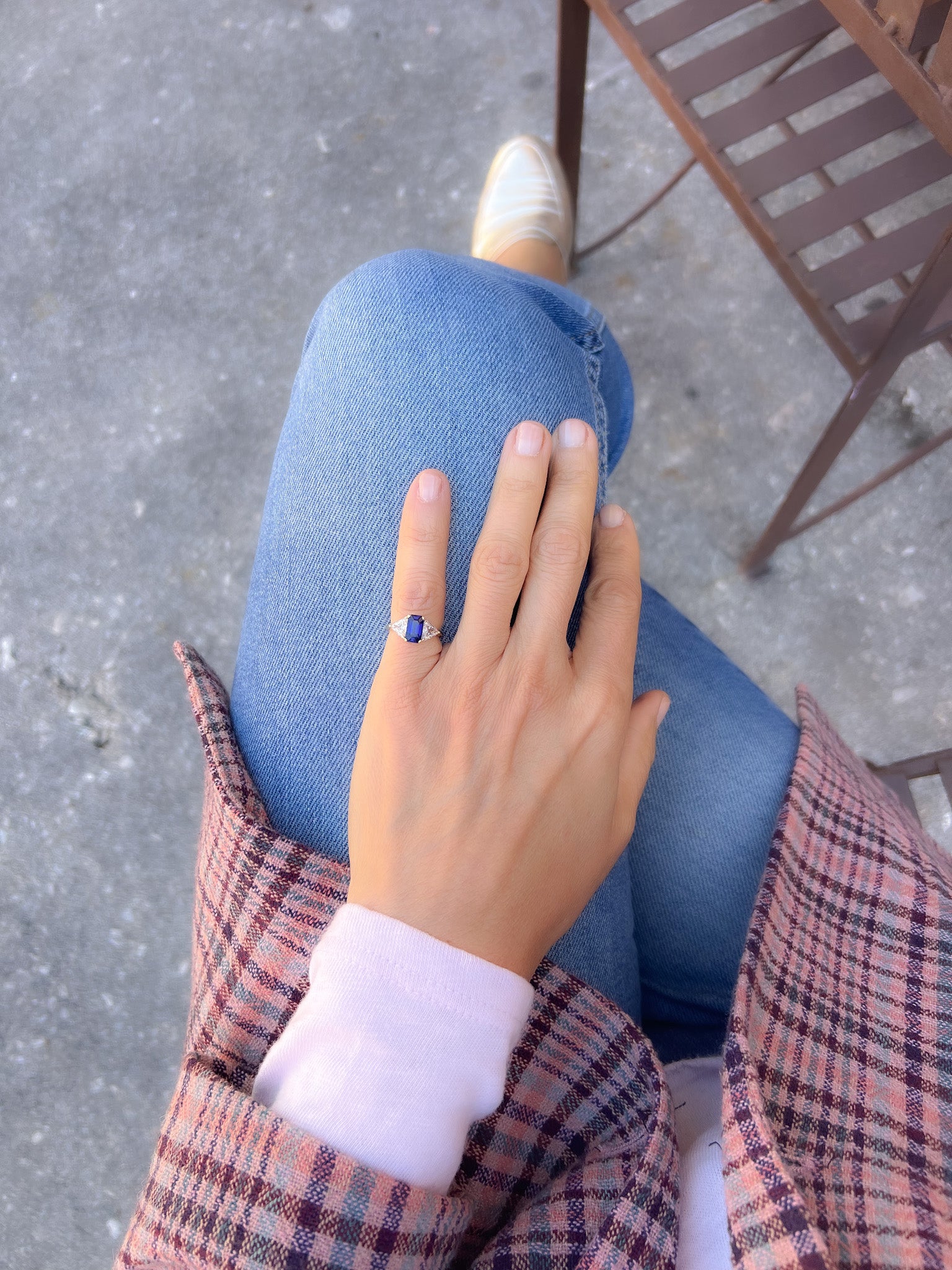 Emerald-cut sapphire ring flanked by two triangular-cut diamonds